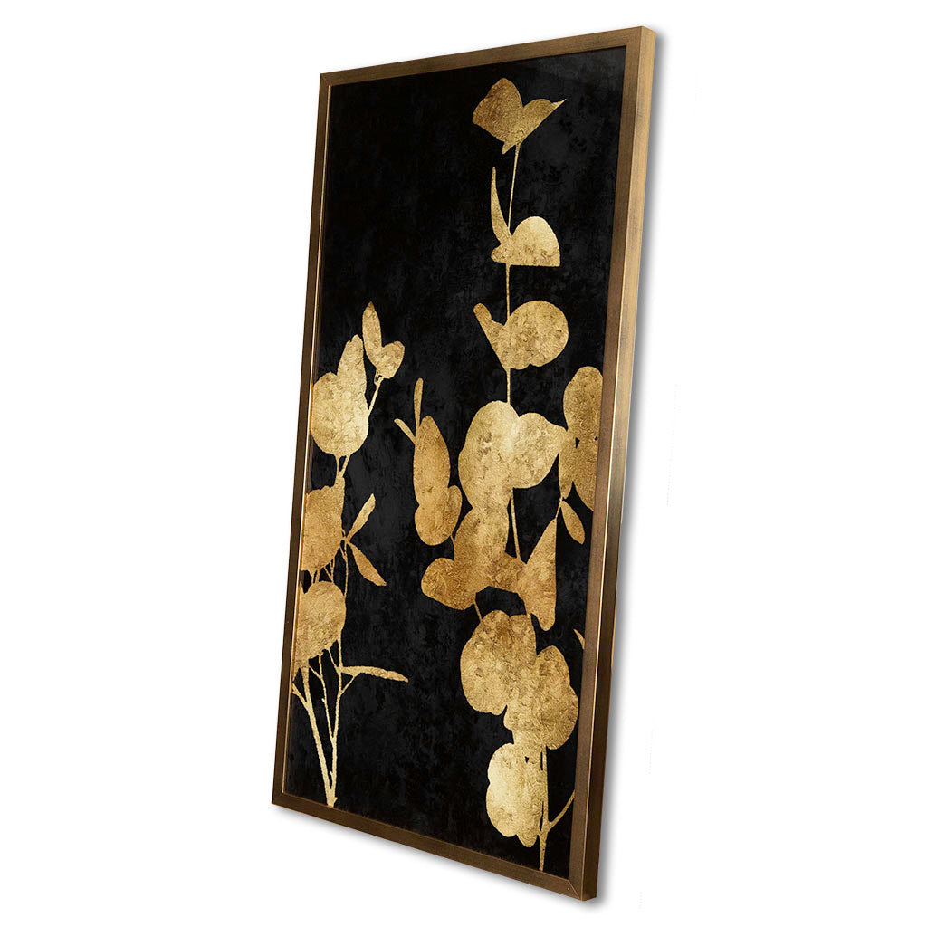 Decorative wall art with gold leaf design on a black background