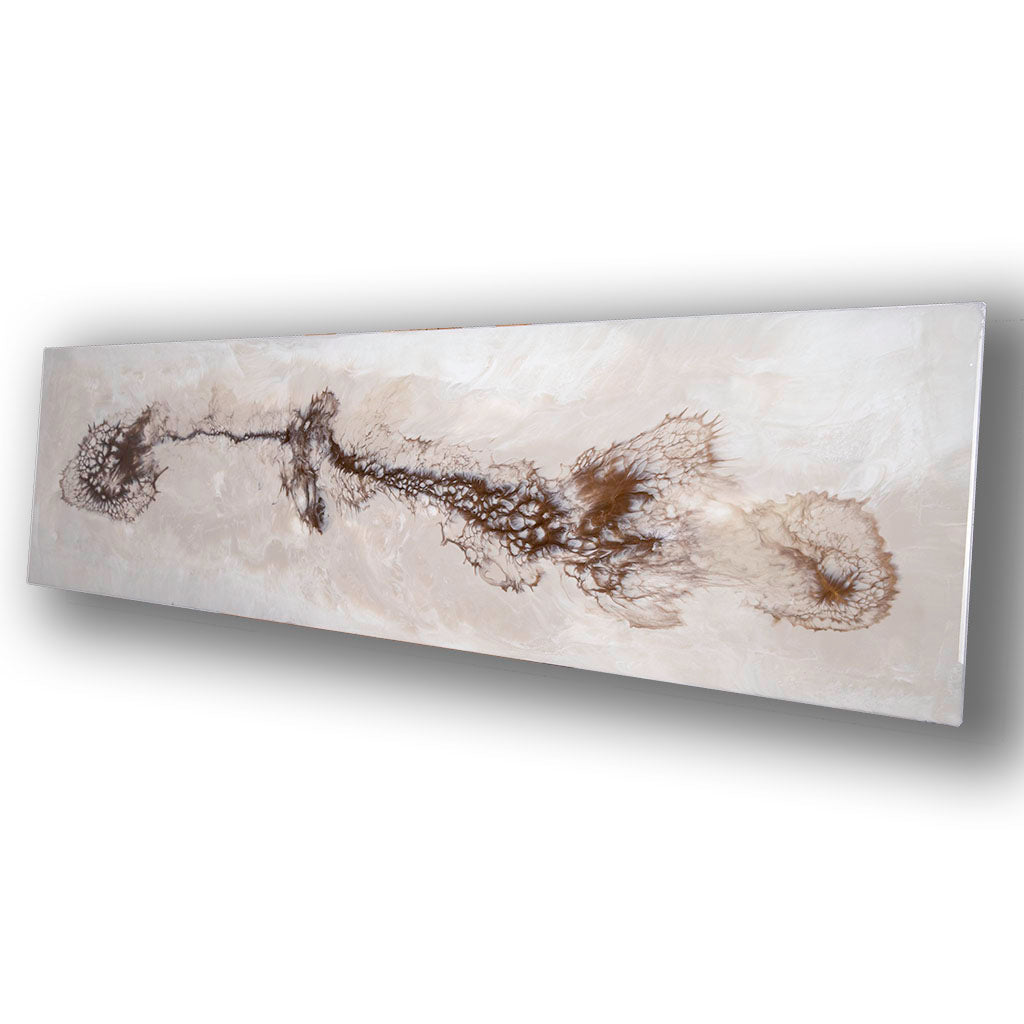 Resin metal wall art in creams and bronze, showing glossy edges.