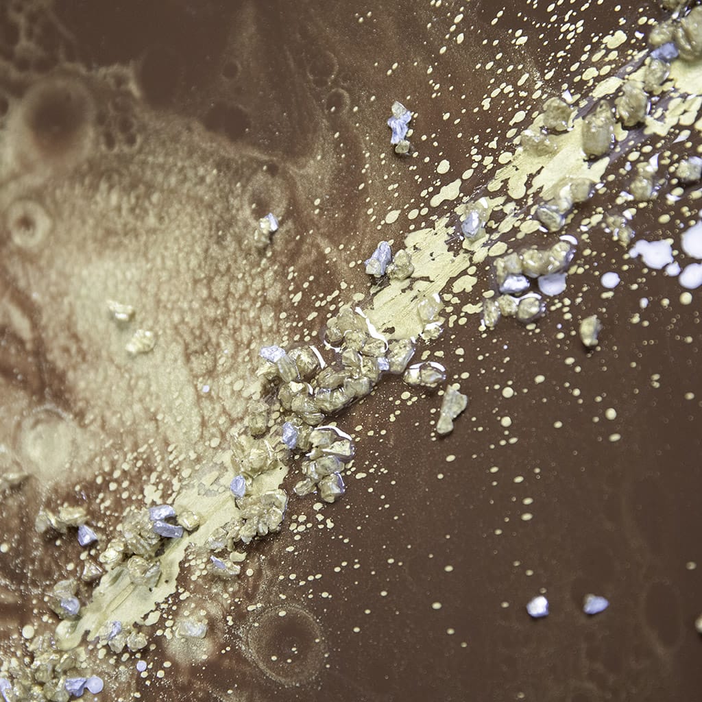 close up detail of texture on an abstract resin wall art in gold, browns silver. Glossy luxury finish, Hand made by elysian bespoke