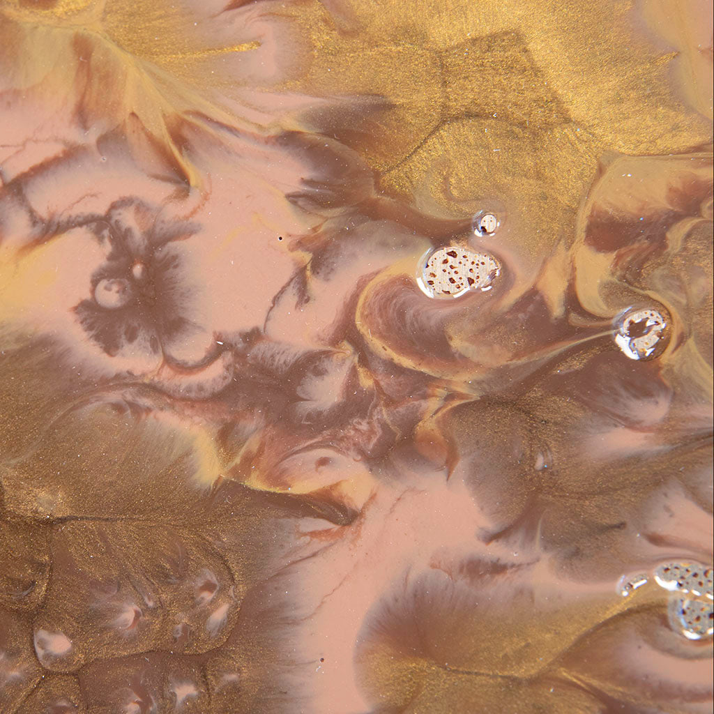 Close-up of a marbled resin with gold and brown colours, hand made in UK