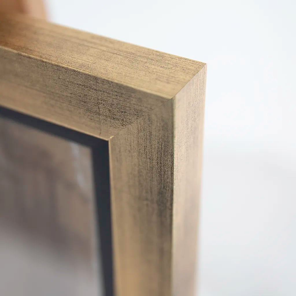 Close-up of a gold rectangular frame corner on a white background