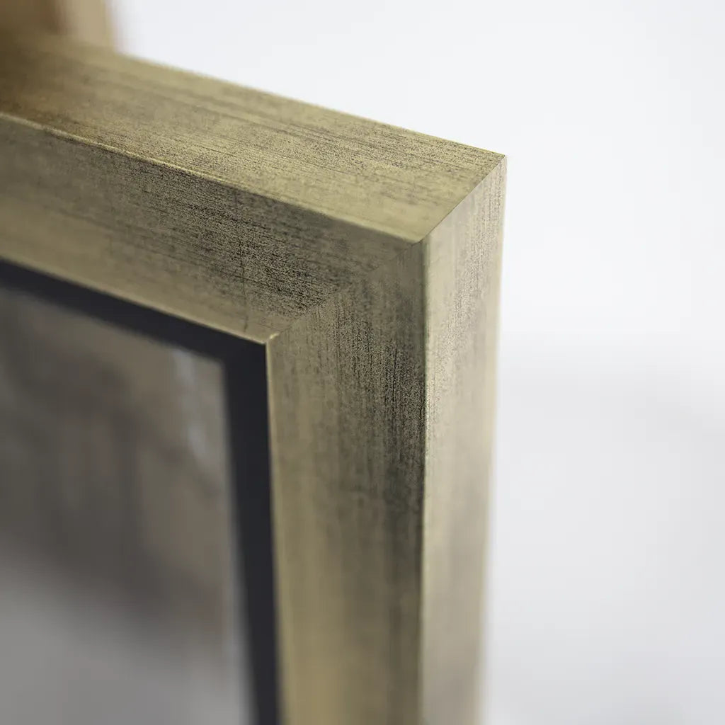 Close-up of a gold rectangular frame corner on a white background