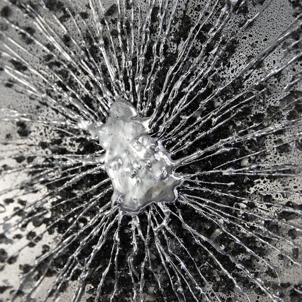 close up detail of luxury metal wall art, with a firework burst design in black and silver. Hand made by paul marshall at elysian bespoke.