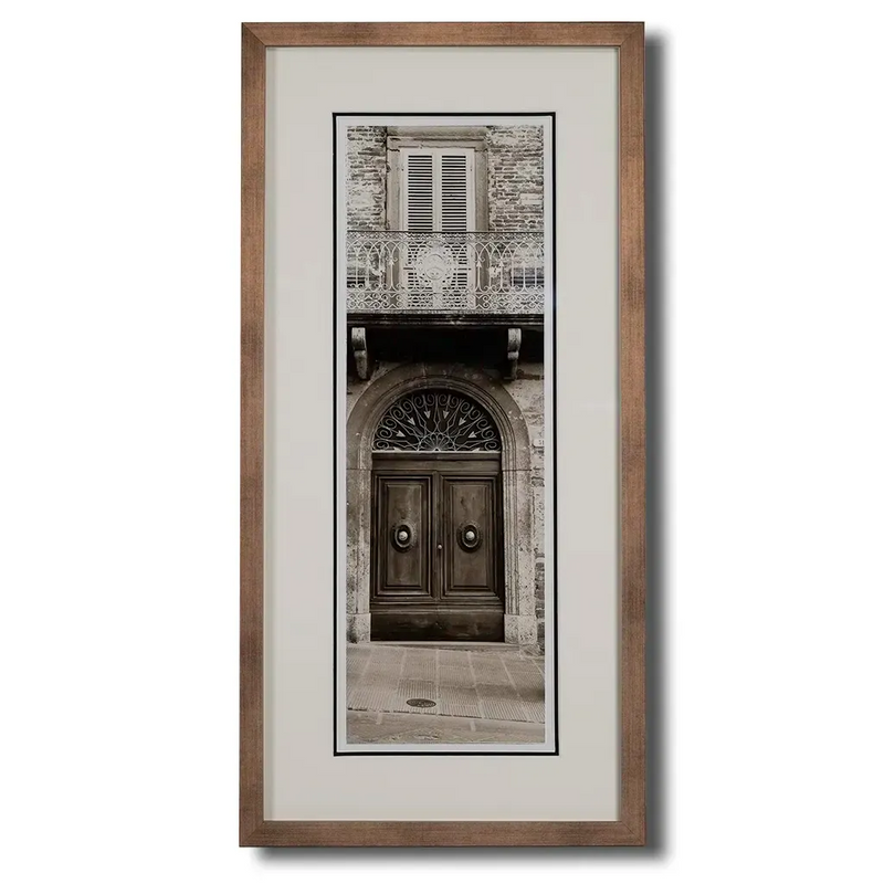 Bronze framed Italian stone archway wall art featuring a historic rustic wooden doorway in monochrome architectural photography. Handmade luxury framed artwork by Elysian Bespoke for contemporary home interiors.