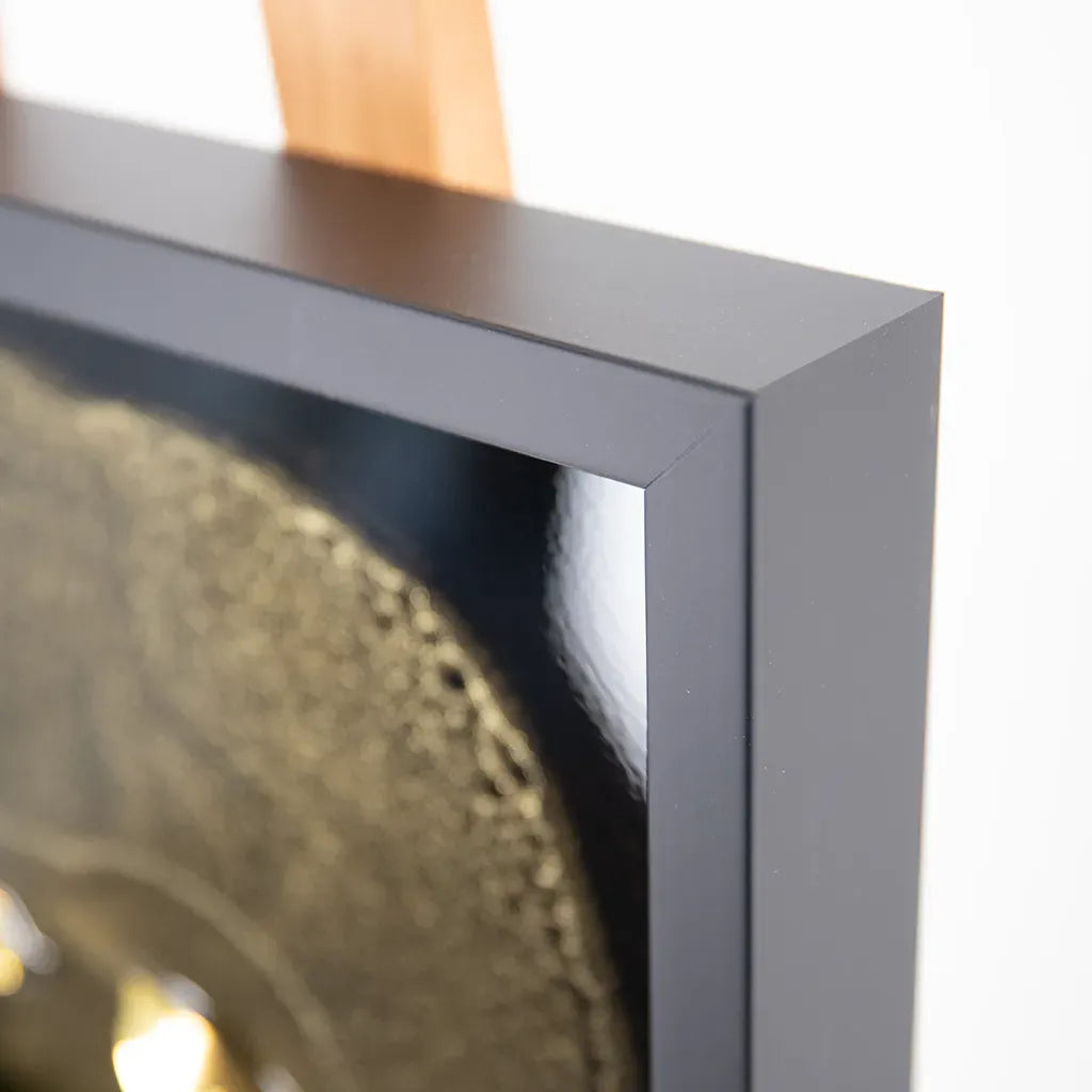 outer frame closeup of One-of-a-kind Armand de Brignac gold bottle and fragments set in textured metallic resin, handmade and framed by British artist Paul Marshall
