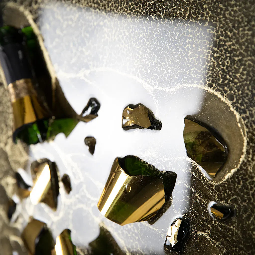 close up of One-of-a-kind Armand de Brignac gold bottle and fragments set in textured metallic resin, handmade and framed by British artist Paul Marshall
