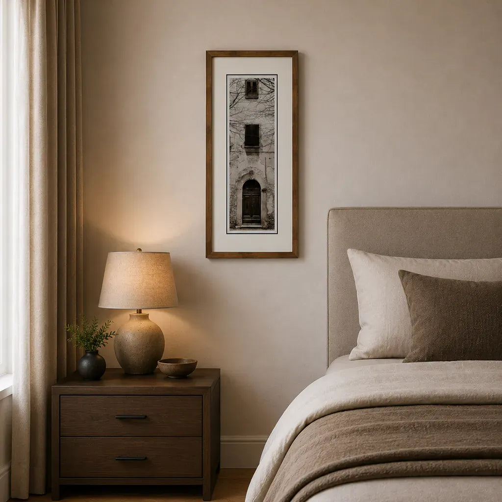 Bronze framed Italian stone archway wall art featuring a historic rustic wooden doorway in monochrome architectural photography. Handmade luxury framed artwork by Elysian Bespoke for contemporary home 