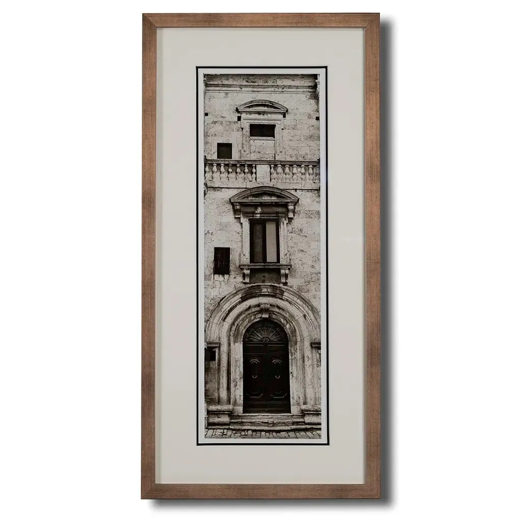 Bronze framed Italian stone archway wall art featuring a historic rustic wooden doorway in monochrome architectural photography. Handmade luxury framed artwork by Elysian Bespoke for contemporary home 