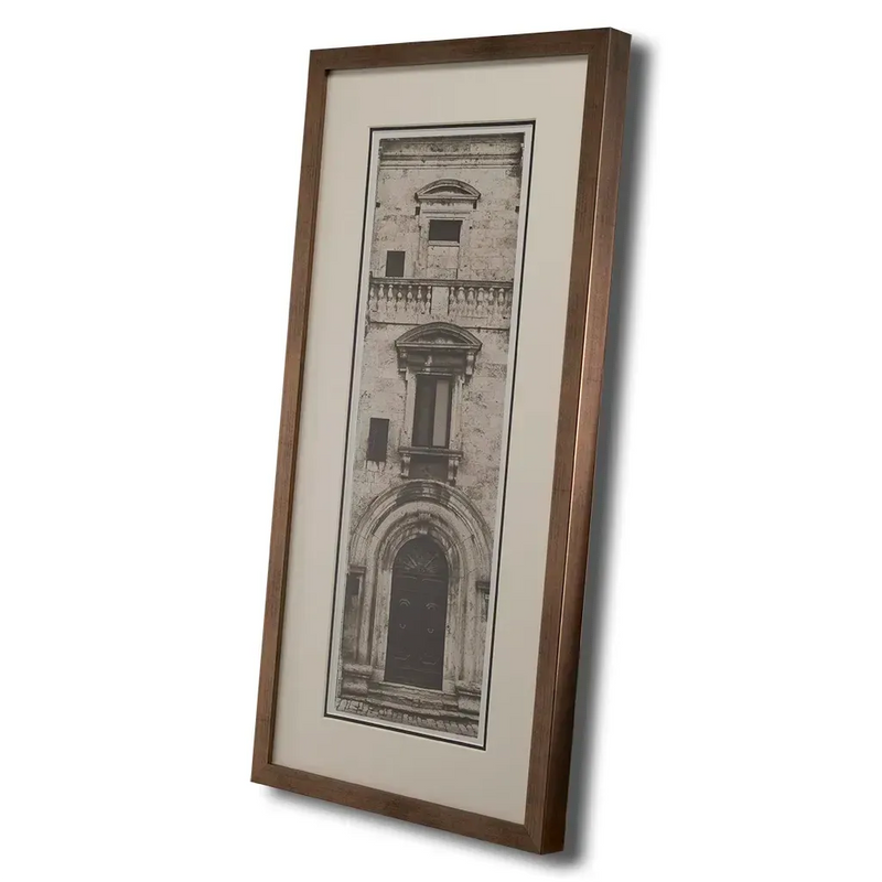 Bronze framed Italian stone archway wall art featuring a historic rustic wooden doorway in monochrome architectural photography. Handmade luxury framed artwork by Elysian Bespoke for contemporary home 