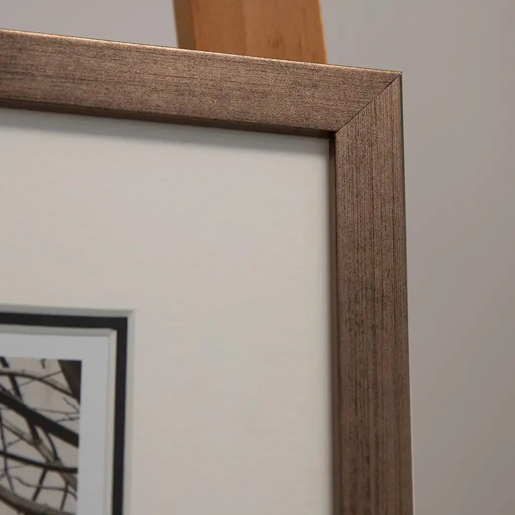 close up of Bronze framed Italian stone archway wall art featuring a historic rustic wooden doorway in monochrome architectural photography. Handmade luxury framed artwork by Elysian Bespoke for contemporary home interiors.